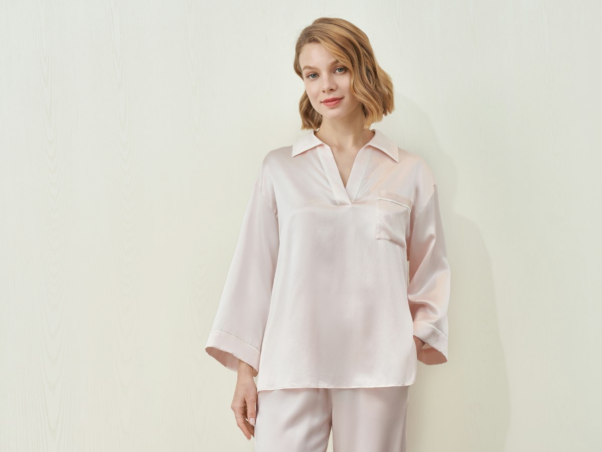 Woman in blush pink silk pyjamas
