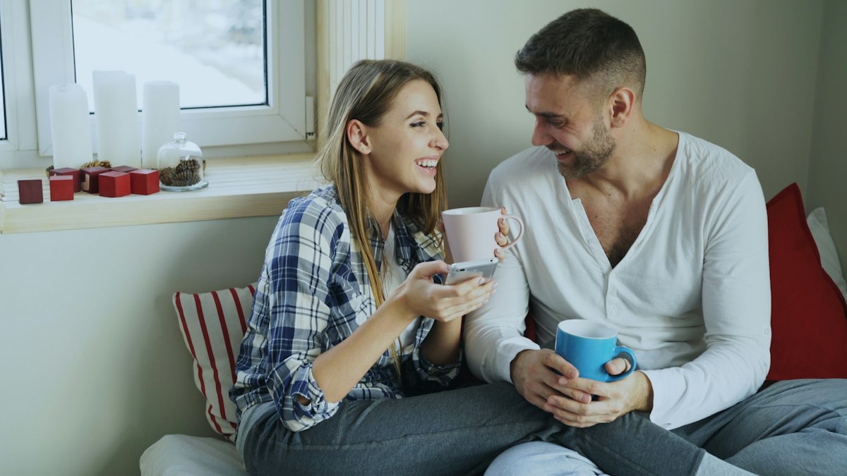 Couple in matching loungewear with coffee
